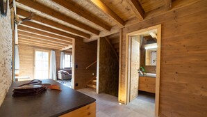 A wooden interior with a desk, drawers, and a mirror.