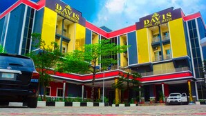 A hotel with a modern facade, featuring two prominent signs reading "DAVIS HOTEL AND SUITES". - DAVIS HOTEL & SUITES (Port Harcourt)
