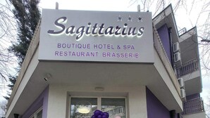 The exterior of Sagittarius Boutique Hotel & Spa Restaurant Brasserie with a clear entrance and a sign indicating it is open. - Boutique Hotel& Relax Sagittarius (Kyustendil)
