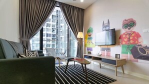 A modern living room with a sofa, a coffee table, a TV, and a large window with curtains.