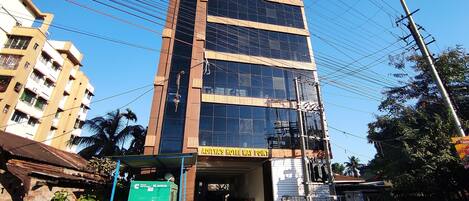 A multi-story hotel with a prominent sign reading "ADITYA'S HOTEL WAY POINT".