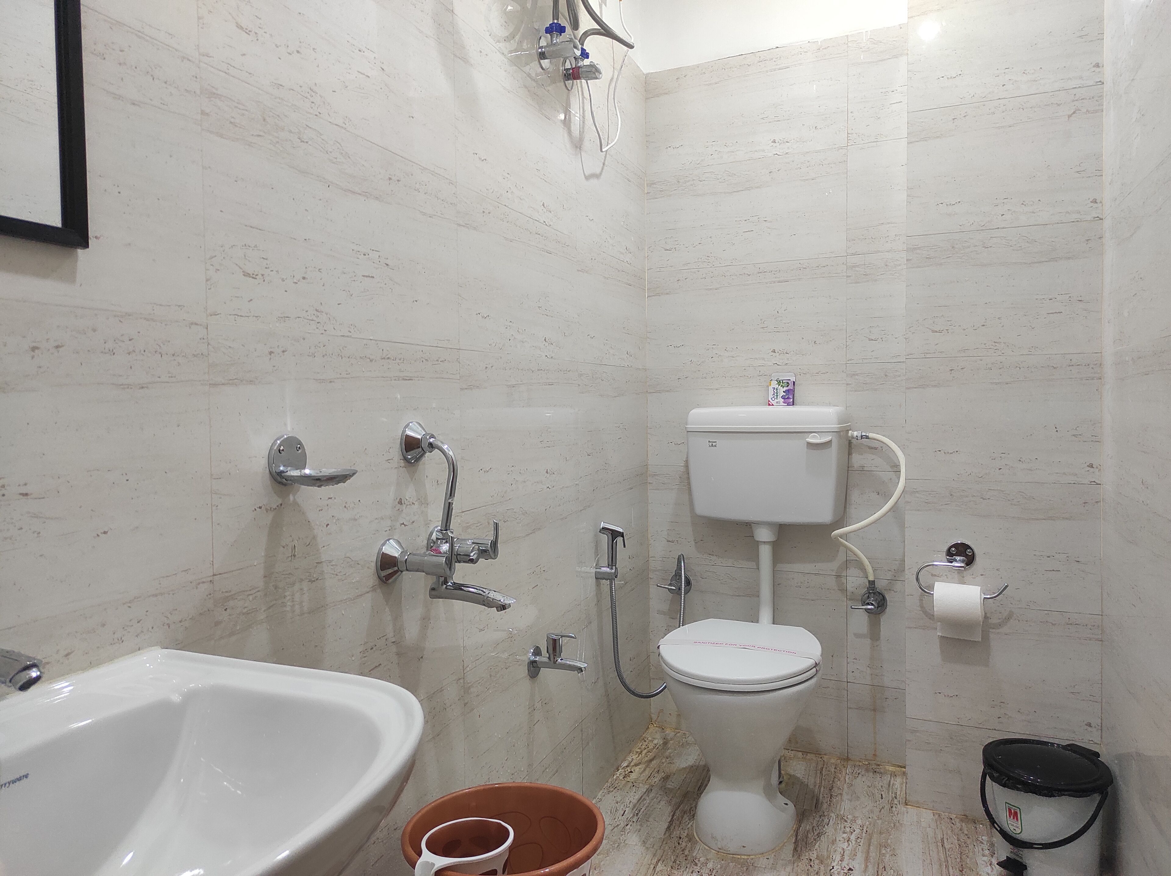 A bathroom with a white sink, toilet, and shower.