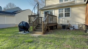 A residential house with a wooden deck, a covered grill, and a small staircase leading to the front door. - Antioch Townhome < 14 Mi to Downtown Nashville! (Antioch)