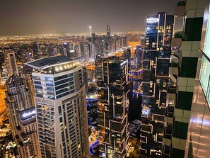 A high-rise building with a modern design, featuring multiple floors and a prominent rooftop structure. - Hawana Premium Hostel (Dubai)