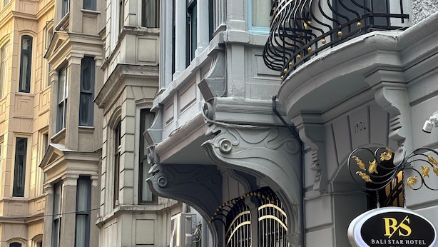 A historic building with ornate architectural details, including a balcony with black wrought iron railings and a sign for the Bali Star Hotel. - Bali Star City Hotel (Istanbul)
