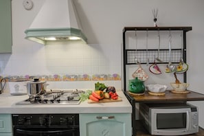 Fully equipped kitchen with gas stove, microwave, and ample counter space for food preparation.