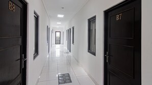 A corridor with doors labeled B7 and B8, leading to rooms. - OYO 93500 Rizki Residence TOS Syariah Near PT Bank KB Bukopin Tbk (Jakarta)
