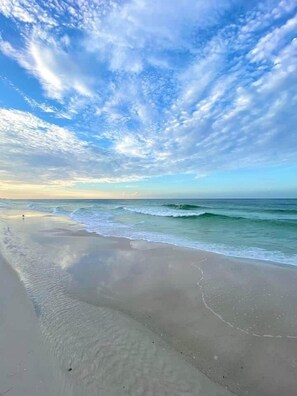 A beach with a clear sky and calm sea.