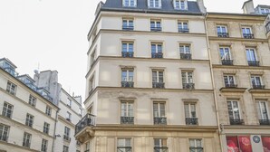 A multi-story building with balconies, large windows, and a classic architectural style.
