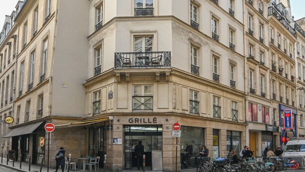 A multi-story building with a ground-floor restaurant named "GRILLE".