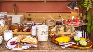 A breakfast setting with various food items and condiments on a table. - toctoctocLisboa (Lisbon)