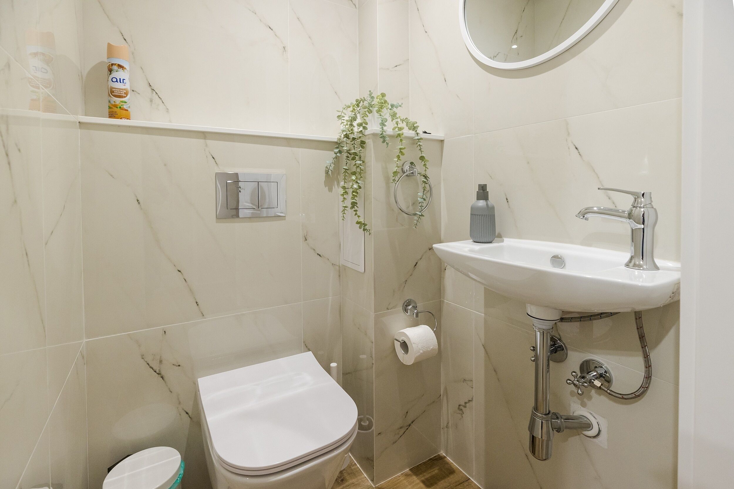 A bathroom with a toilet, sink, and shower.