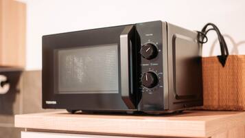 Un horno microondas Toshiba sobre una encimera de madera.