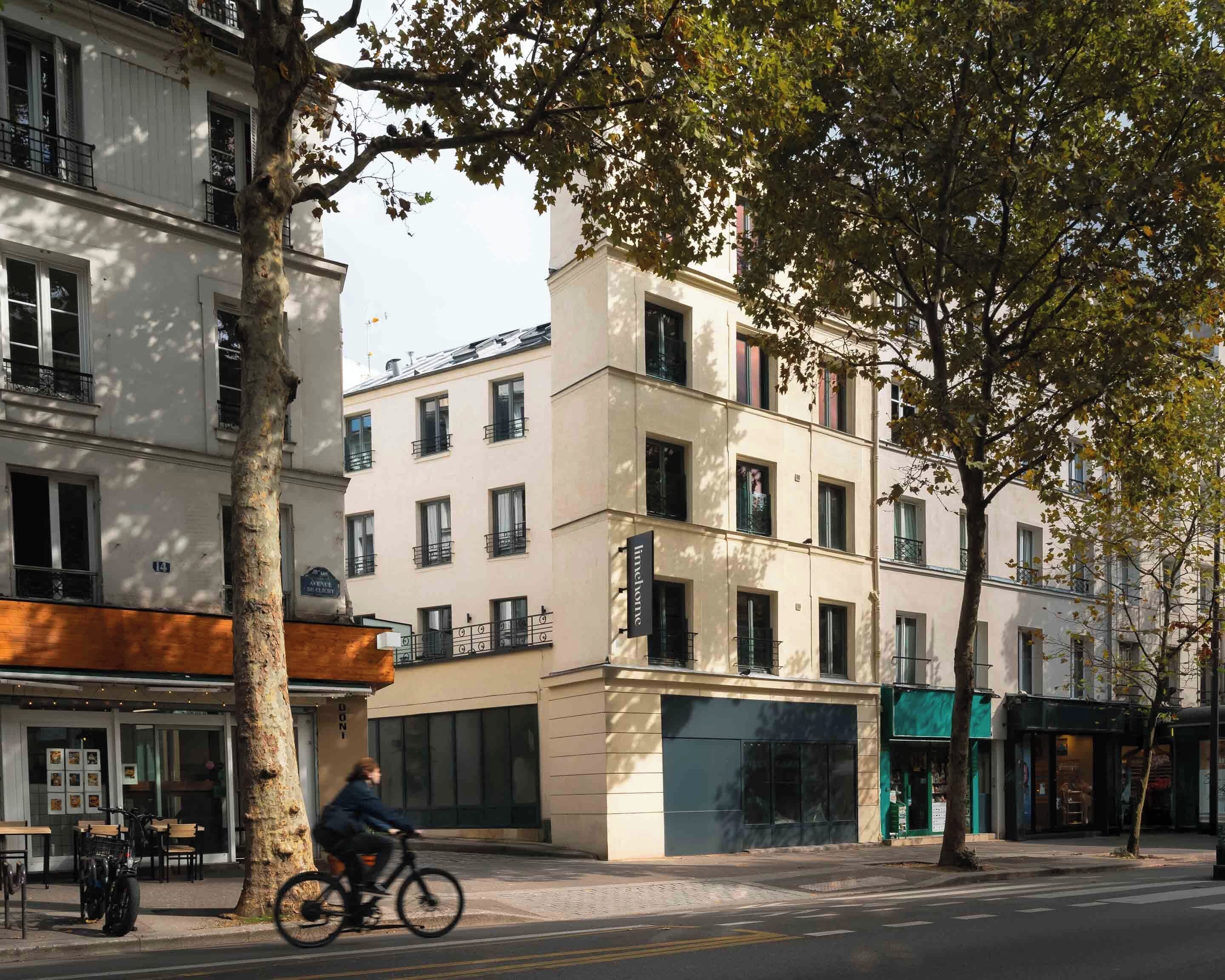A multi-story building with a ground-floor restaurant and a bike parked outside.