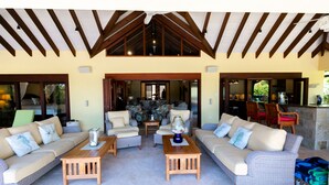 A spacious living area with two sofas, a coffee table, and a dining table.