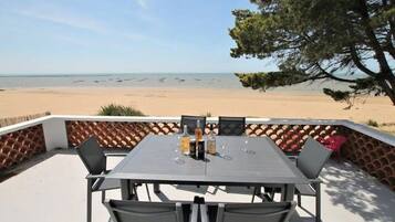 Enjoy a casual meal on the patio overlooking the beach.