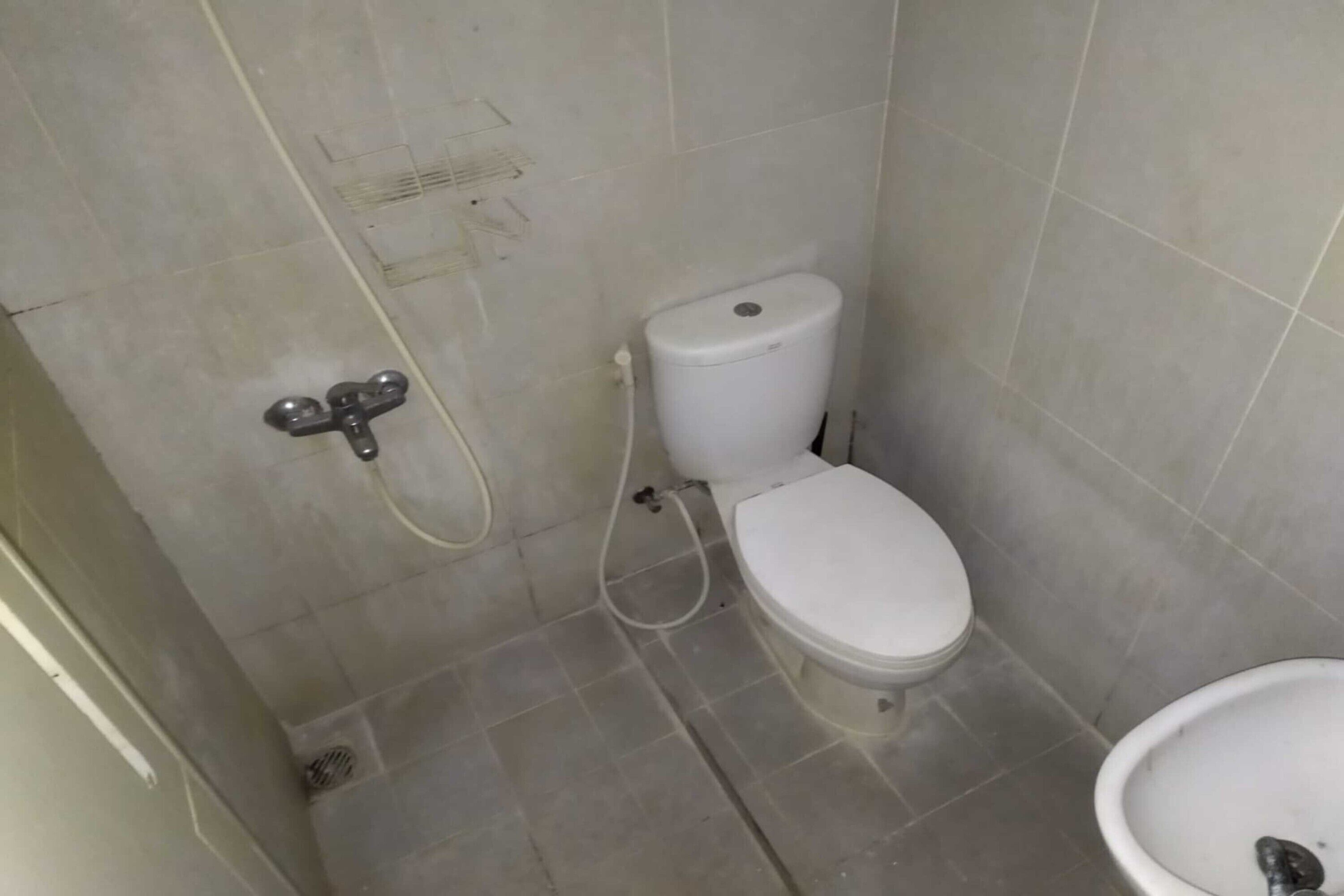 A small bathroom with a toilet, bidet, and a sink.