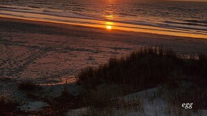 A sunset over a beach with waves and sand. - OCEAN FRONT @ CHERRY GROVE POINT - SALT AIR, SEA BREEZES, GORGEOUS SUNRISES (North Myrtle Beach)