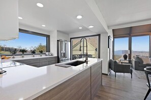 Prepare meals in the spacious kitchen with a large island and sink, perfect for cooking and relaxation.