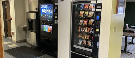 A vending area with a cold drink machine and a snack vending machine.