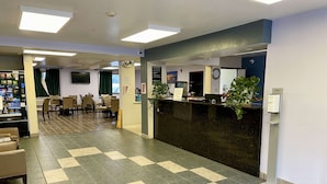 A reception area with a check-in counter, seating area, and a vending machine. - SureStay by Best Western Prince Frederick (Prince Frederick)