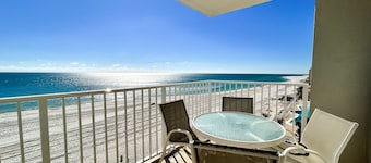 Oceanfront condo with pool, grilling area, alfresco dining, internet, W/D, & AC
