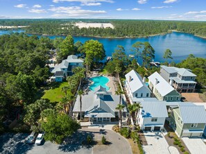 A resort with multiple buildings, a swimming pool, and a view of a lake. - Pet Friendly! Bikes! Inlet Beach! Community Pool! Minutes to the Beach! (Rosemary Beach)