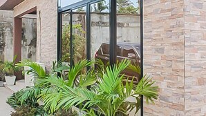 A modern building with a stone facade and large windows. - 2 Bed/2.5 Bath Villa (Lewa) (Monrovia)