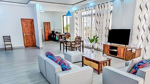 A modern living room with a sofa set, a coffee table, and a television. - 2 Bed/2.5 Bath Villa (Lewa) (Monrovia)