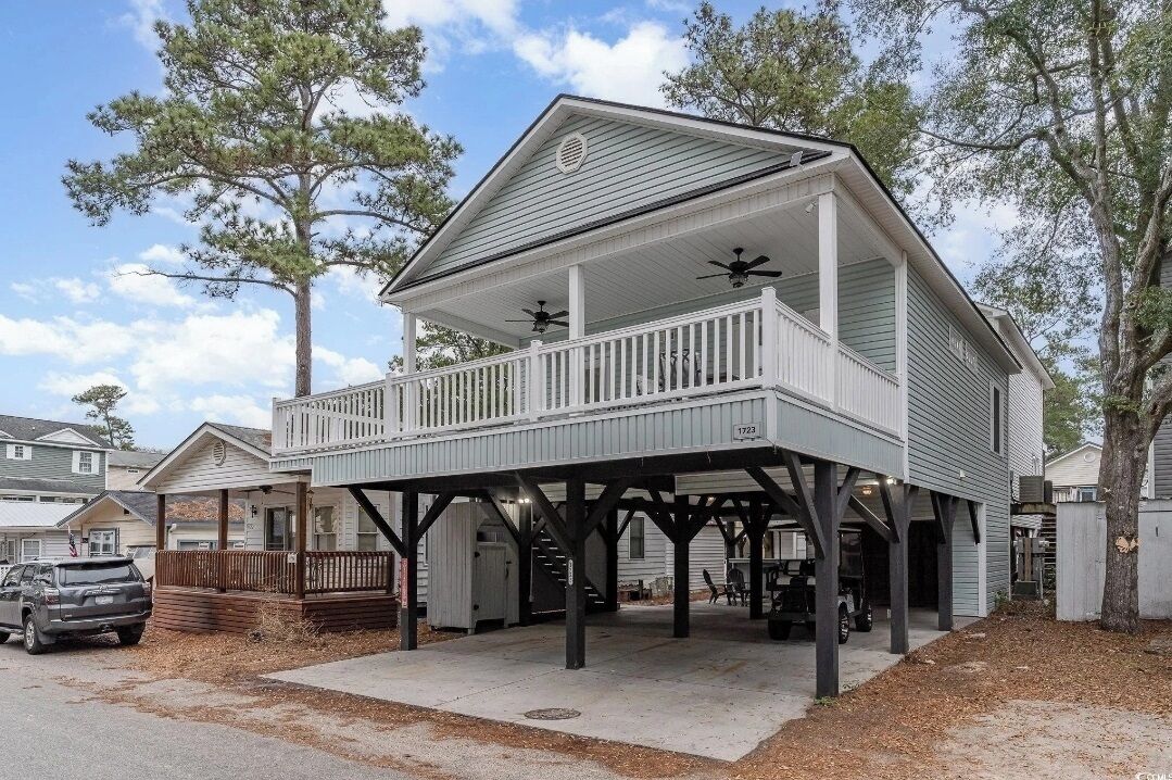 A two-story house with a covered porch and a garage.