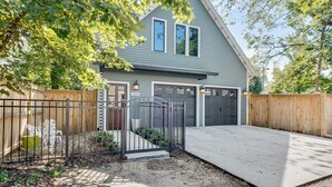 A two-story house with a garage, a front porch, and a driveway.