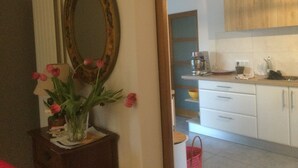 A kitchen with white cabinets, a coffee maker, and a sink.