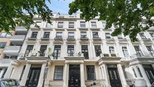 A multi-story building with a symmetrical facade, large windows, and a central entrance with a black door. - Stylish Studio with Private Bath • Near Hyde Park (Greater London)