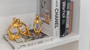 A bookshelf with books and decorative items.