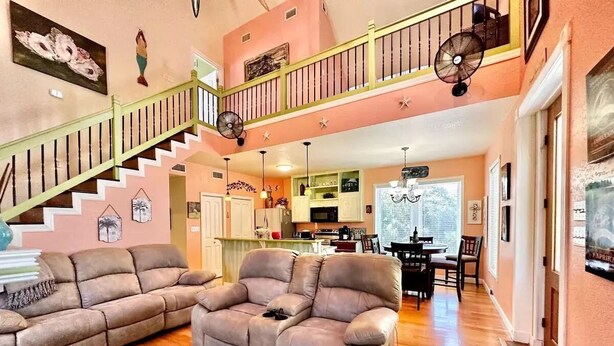 A spacious living area with two sofas, a dining table, and a kitchen in the background. - 3 Bedroom House near Old Town (Bay St. Louis)
