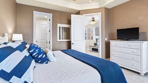 A bedroom with a bed, a TV, a dresser, and a ceiling fan. - Cliffside Lake Retreat - 2 Bdr, Walk to Table Rock (Branson)