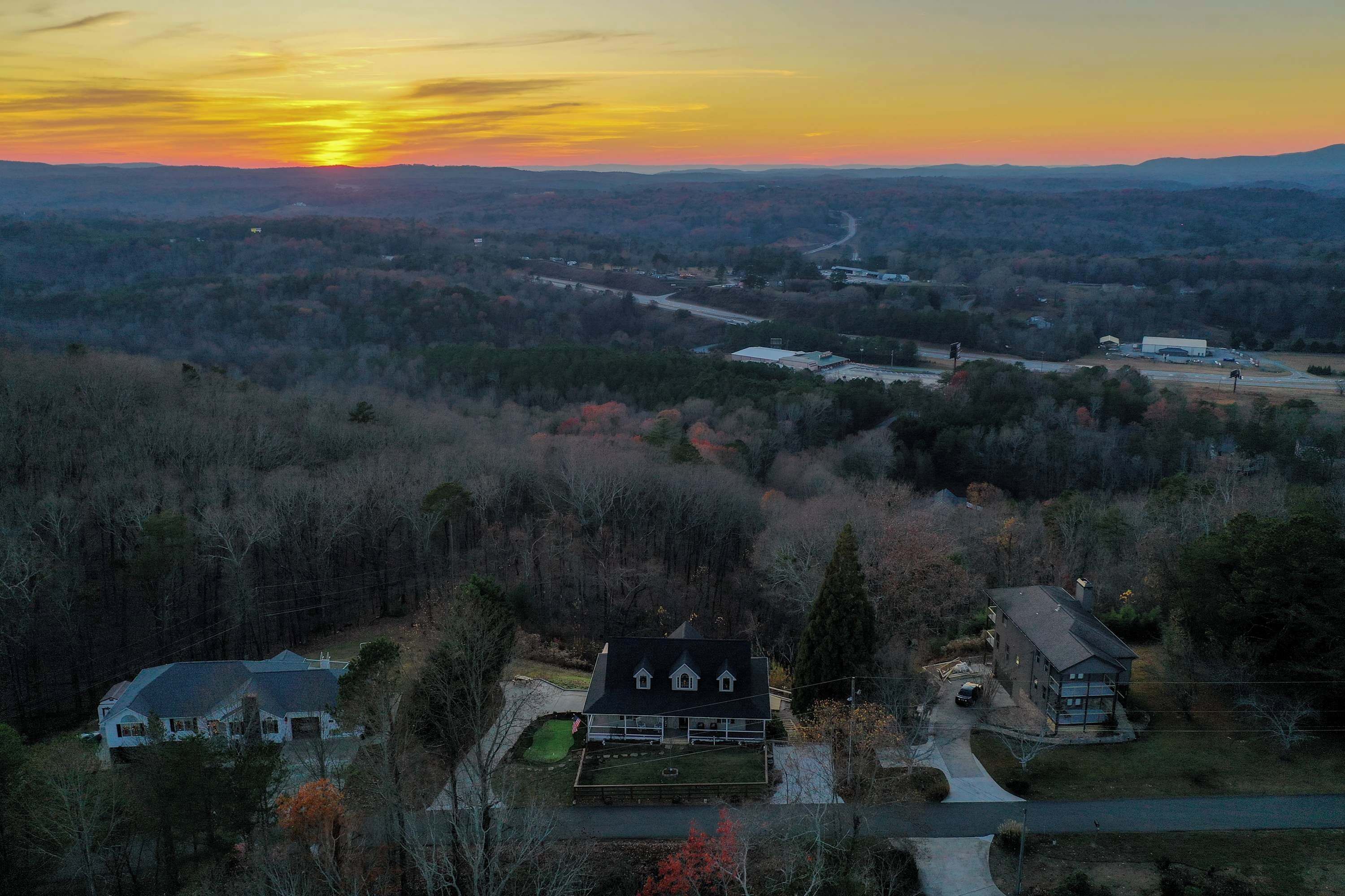 A large house with a spacious front yard and a driveway leading to a garage.
