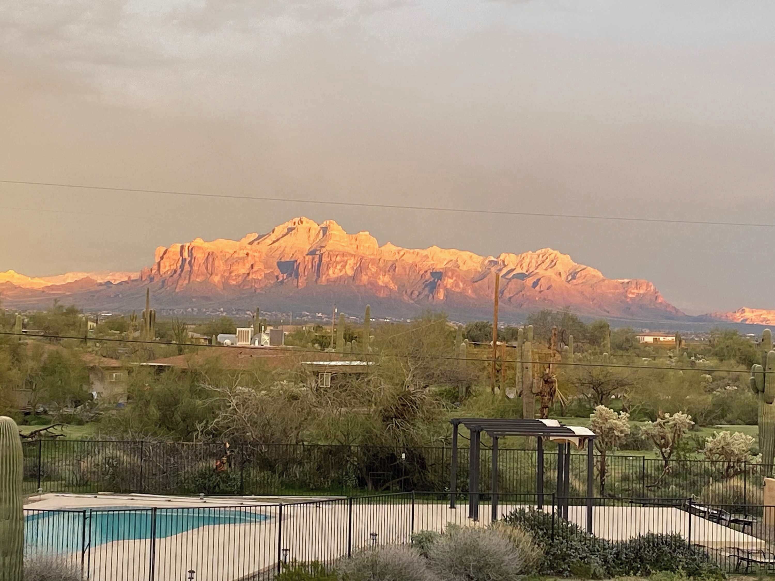 A pool area with a mountain in the background.