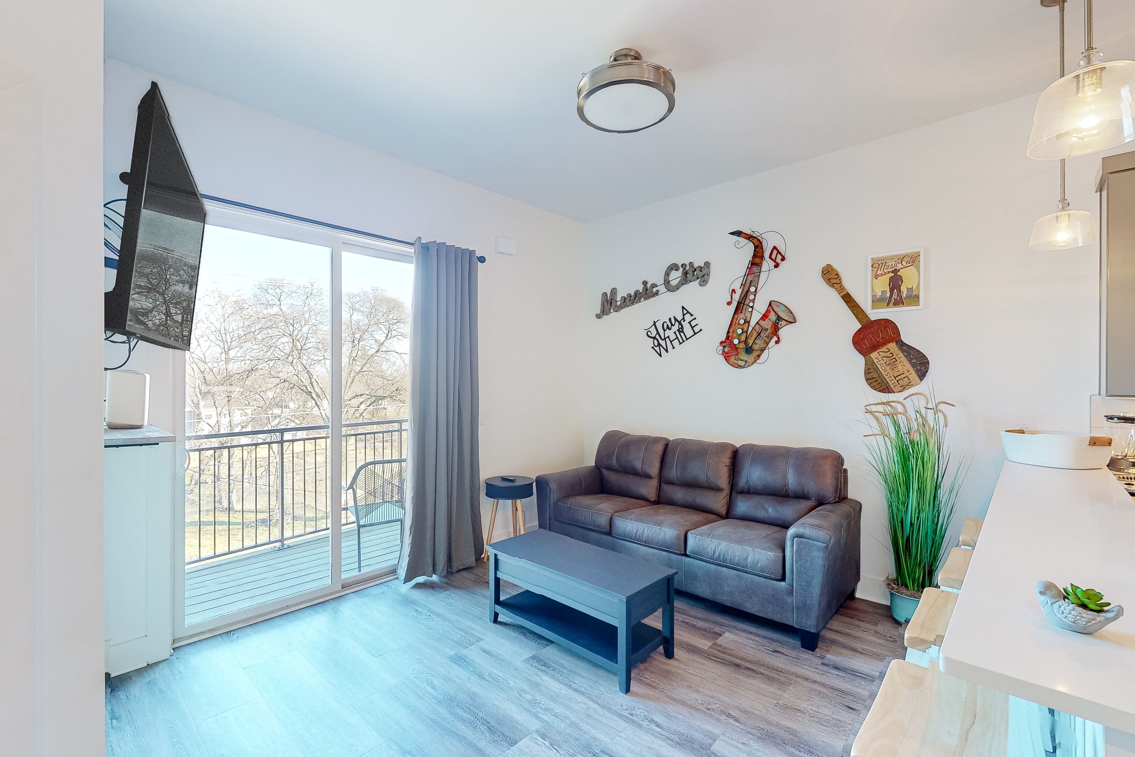 Music-themed modern condo with city views, balcony, open layout, W/D, & AC