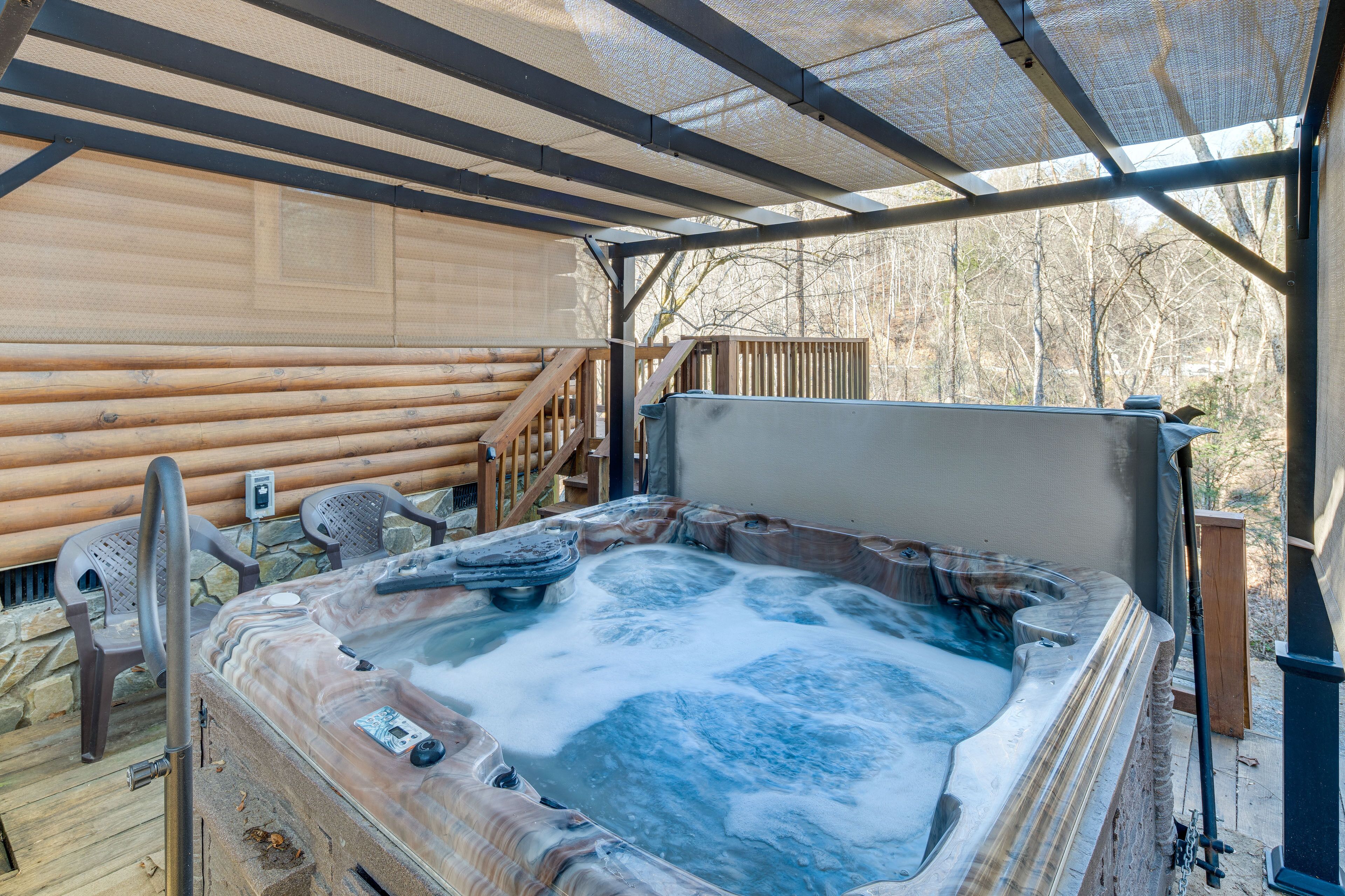 A hot tub with a wooden deck and a covered area.
