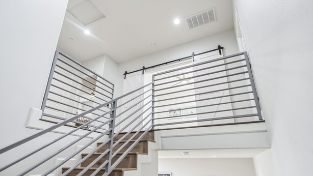 A modern staircase with metal railings and a white interior. - Disney Luxury 3 Bedroom - Comfortable 12 Guests + EV (Midway City)