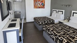 A hotel room with two beds, a desk, a chair, a telephone, and a painting on the wall. - La Vid Aguascalientes (Aguascalientes)