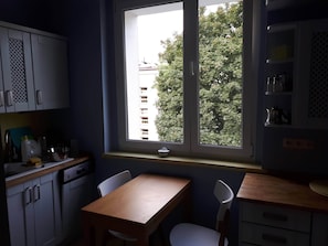 A small kitchen with a window, a table, and chairs.