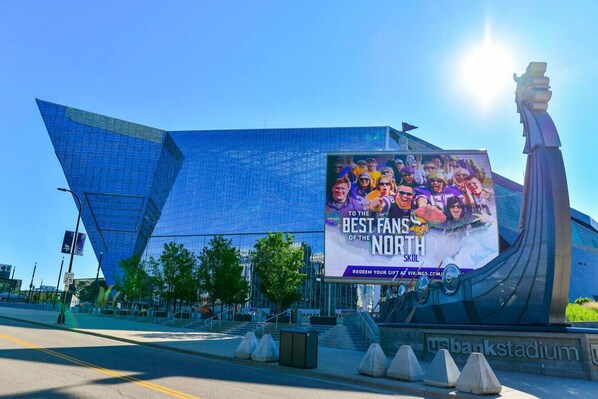Un stade avec un grand panneau publicitaire annonçant un événement sportif.