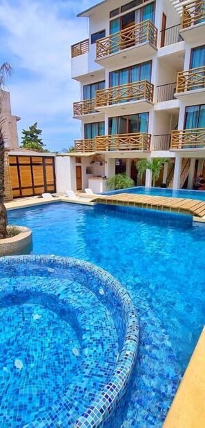 A hotel with a swimming pool, multiple balconies, and a modern architectural design. - Hotel Casa Shula Acapulco (Coyuca de Benitez)