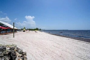 On the beach, white sand, beach cabanas, sun loungers