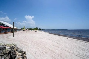On the beach, white sand, beach cabanas, sun-loungers