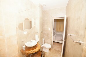 Separate bathtub and shower, towels, soap, toilet paper