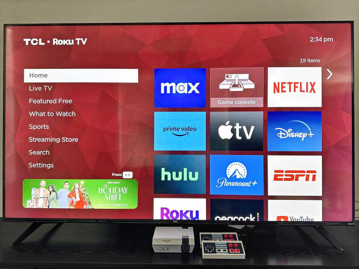 A TCL Roku TV displaying a variety of streaming service logos.