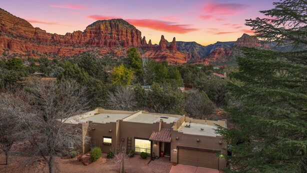 A house with a garage, surrounded by trees and a desert landscape. - Sedona Retreat W/ Tesla Mobile Charger (Sedona)
